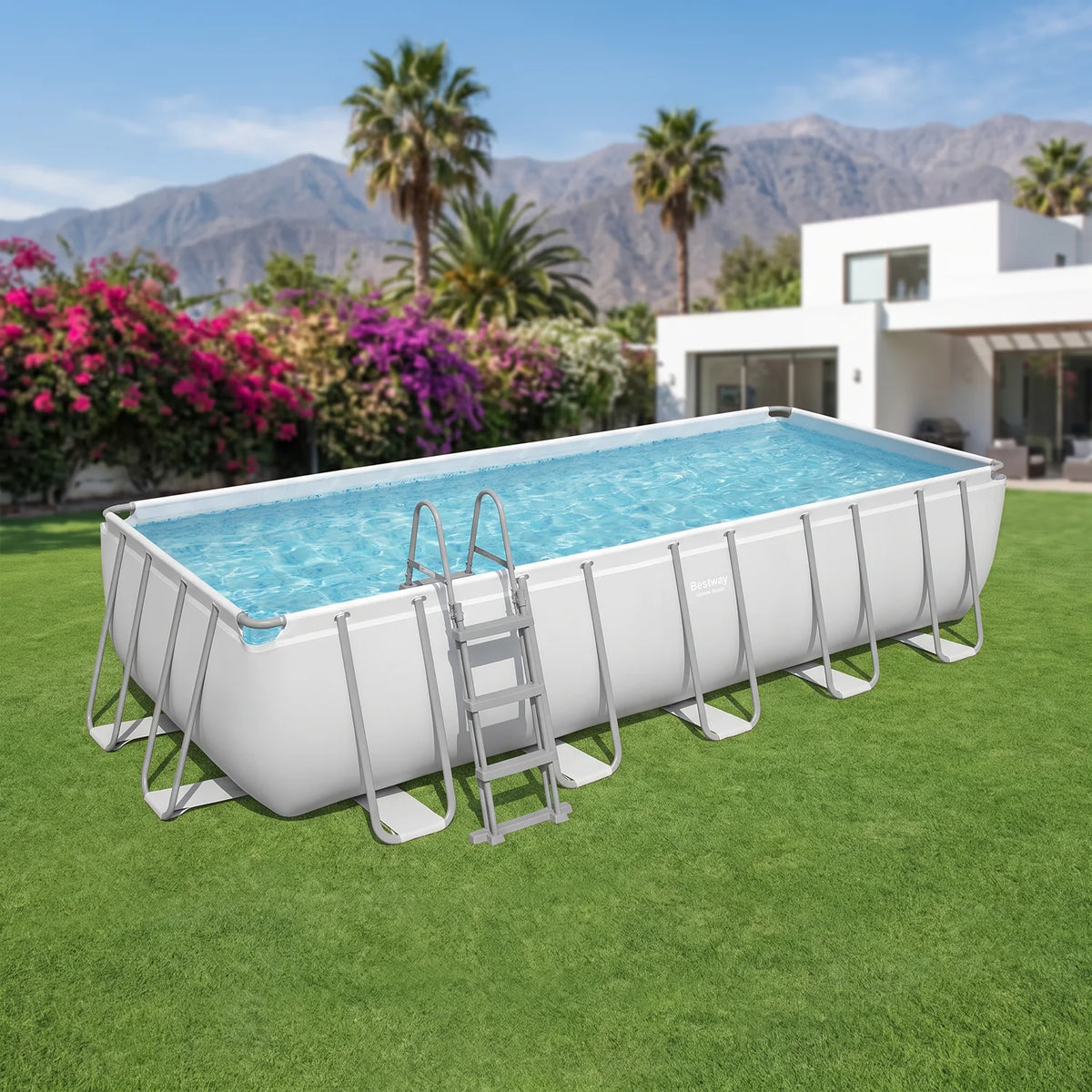 Piscina Bestway Power Steel 6,40 x 2,74 x 1,32 m armada en un patio con la cordillera de fondo